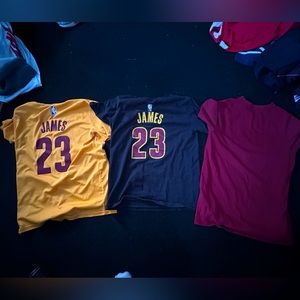 3 Cleveland cavaliers shirts, two of which are Lebron James jersey t-shirts.